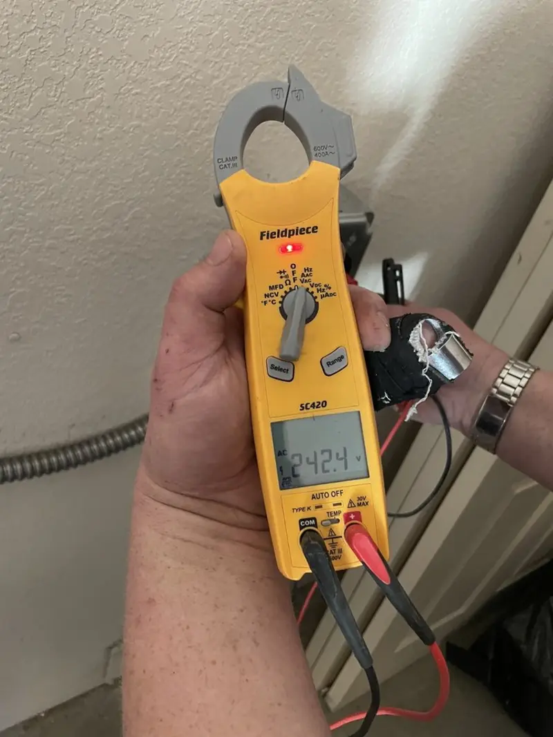 Voltage testing with clamp meter during Ceiling Fan Installation in Wolf Trap